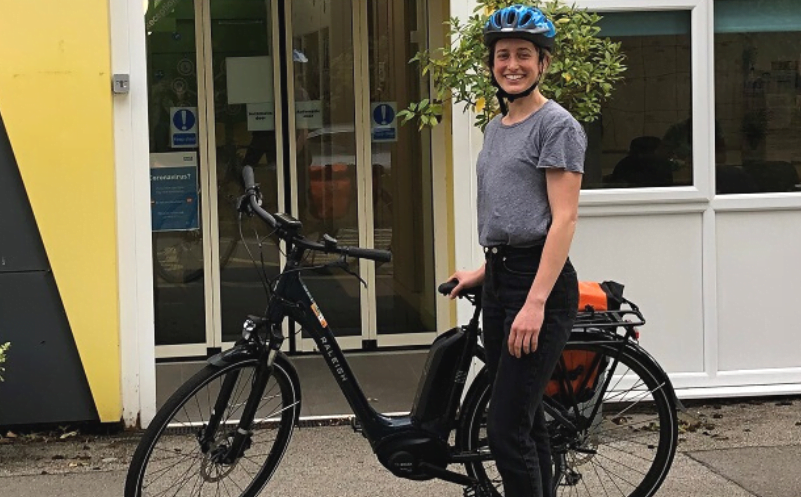 Picture of NHS staff member posing with an e-bike.