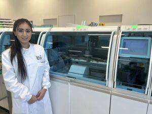 Anisa Ali, Senior Specialist Biomedical Scientist wearing her white unifrom in the lab.